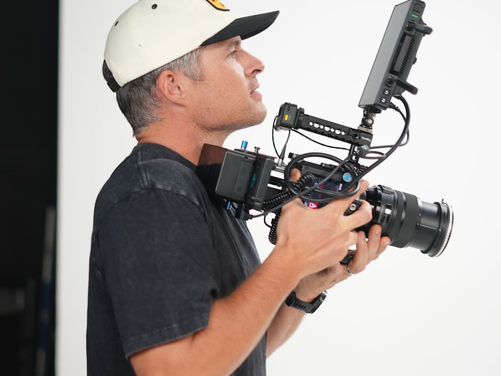 Camera operator filming with a gimbal rig